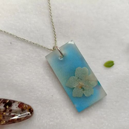 Shimmery Resin Jewellery With Preserved Baby Flower